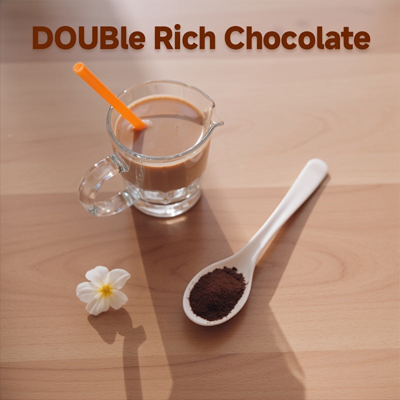 Glass mug of double rich chocolate with a spoonful of cocoa powder and a white flower on a wooden surface.